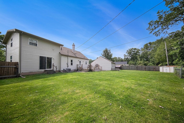 1836 W Argus Ct, Jackson, MI 49203 - back of house featuring entry steps, a fenced backyard, and a storage unit