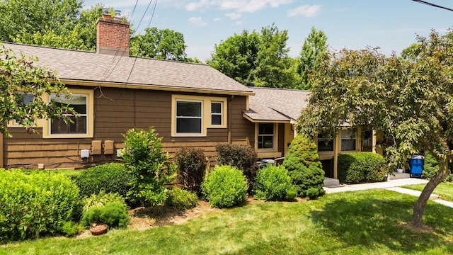 2834 Pittsfield Blvd, Ann Arbor, MI 48104 - ranch-style home featuring a shingled roof, a chimney, and a front yard
