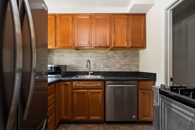 2834 Pittsfield Blvd, Ann Arbor, MI 48104 - kitchen with stainless steel appliances, tasteful backsplash, dark countertops, and brown cabinetry