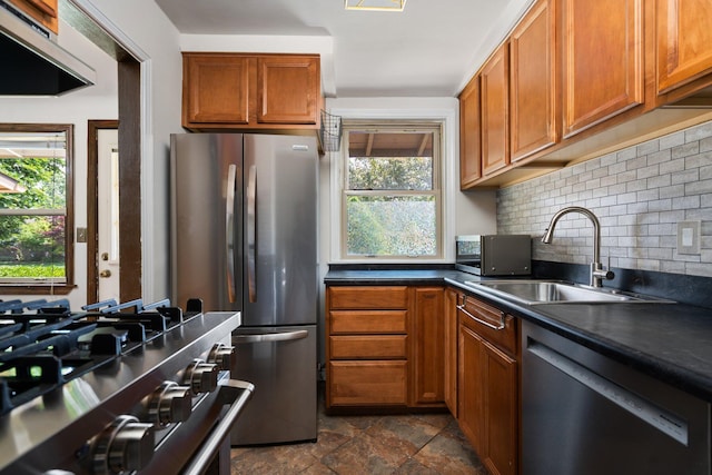 2834 Pittsfield Blvd, Ann Arbor, MI 48104 - kitchen with stainless steel appliances, extractor fan, decorative backsplash, dark countertops, and brown cabinetry