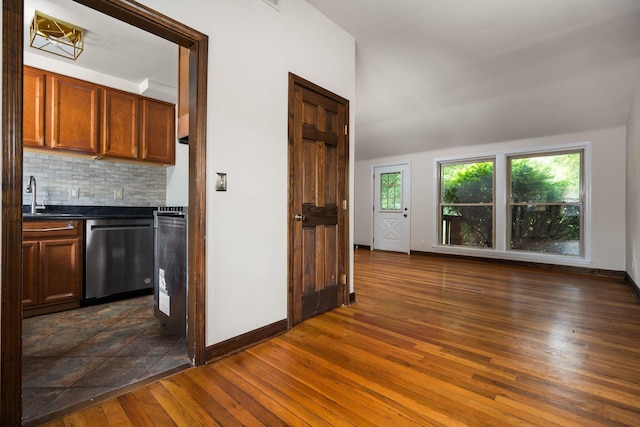 2834 Pittsfield Blvd, Ann Arbor, MI 48104 - kitchen featuring dishwasher, dark wood-style floors, dark countertops, backsplash, and brown cabinetry