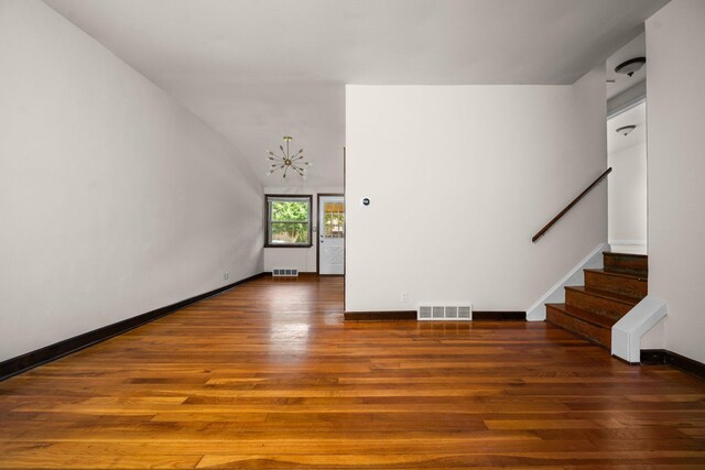 2834 Pittsfield Blvd, Ann Arbor, MI 48104 - unfurnished living room with a chandelier, wood finished floors, and stairway