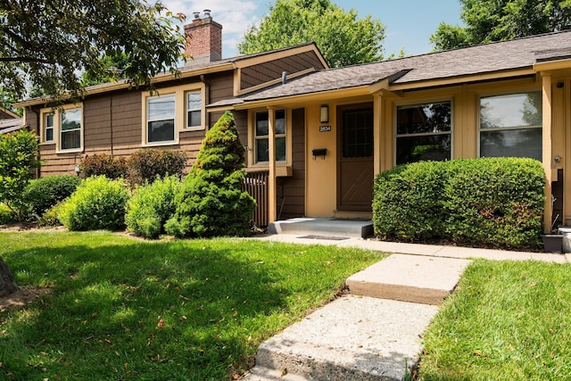 2834 Pittsfield Blvd, Ann Arbor, MI 48104 - view of front facade featuring a chimney and a front lawn