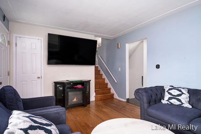4128 Michael Ave SW, Wyoming, MI 49509 - living area with wood finished floors, stairway, and a lit fireplace