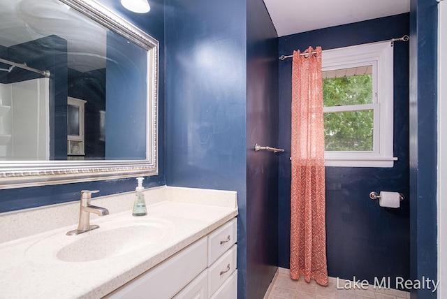4128 Michael Ave SW, Wyoming, MI 49509 - bathroom with vanity, tile patterned floors, and a shower