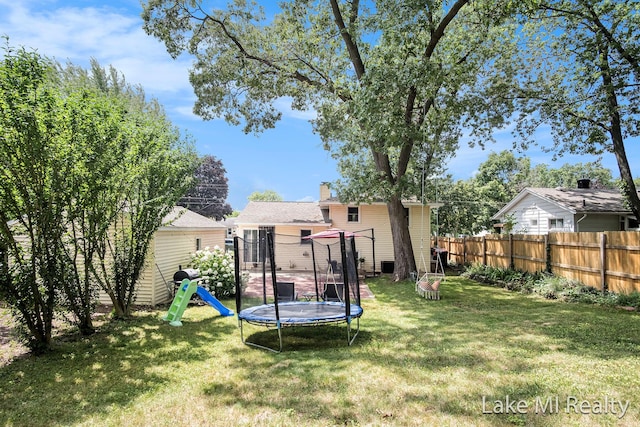 4128 Michael Ave SW, Wyoming, MI 49509 - view of yard featuring a trampoline and a playground