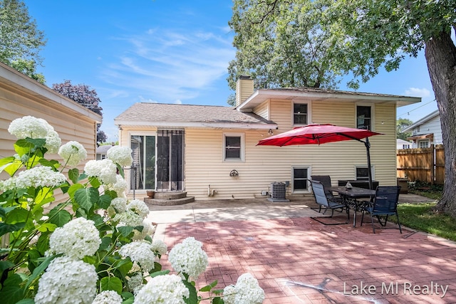 4128 Michael Ave SW, Wyoming, MI 49509 - rear view of property with a patio, a chimney, and entry steps