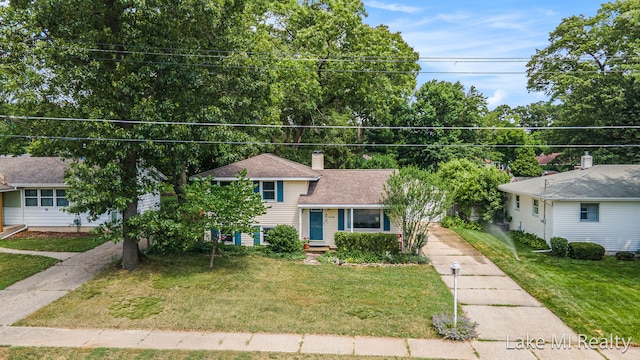 4128 Michael Ave SW, Wyoming, MI 49509 - split level home with a front lawn, a chimney, and roof with shingles