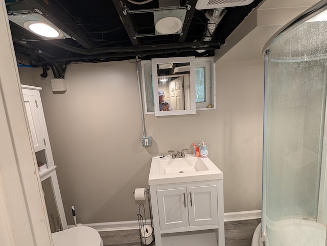 1236 Fulton Ave, Grand Haven, MI 49417 - bathroom with a shower stall, vanity, and wood finished floors