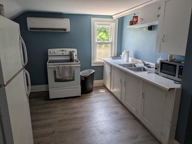 1236 Fulton Ave, Grand Haven, MI 49417 - kitchen with white appliances, a wall mounted AC, light wood-style flooring, light countertops, and white cabinets