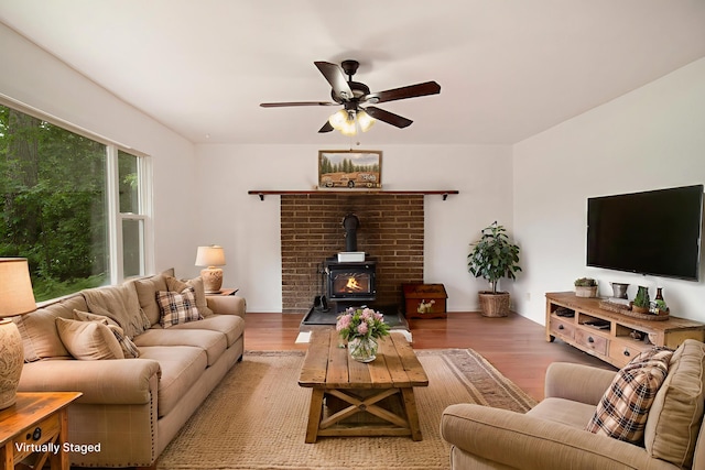105 S Emerson Lake Rd, Branch, MI 49402 - living room featuring ceiling fan, a wood stove, and wood finished floors