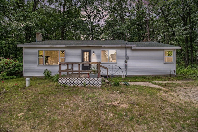 105 S Emerson Lake Rd, Branch, MI 49402 - view of front of property with a front yard, view of wooded area, and a shingled roof