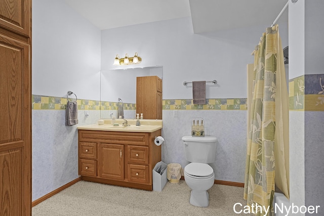 4232 Limousin Ct SW, Grandville, MI 49418 - bathroom featuring wainscoting, vanity, tile walls, and shower / bath combo with shower curtain