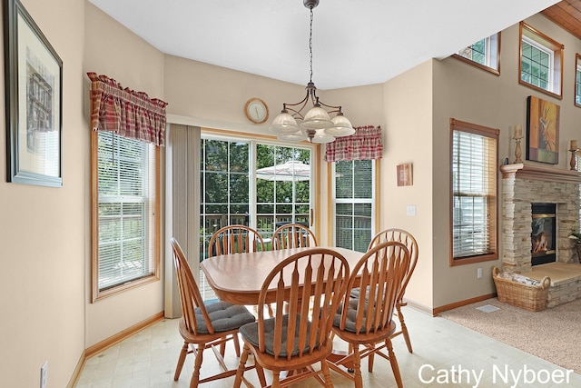4232 Limousin Ct SW, Grandville, MI 49418 - dining room with a chandelier, light floors, and a stone fireplace