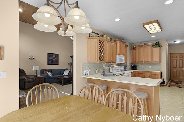 4232 Limousin Ct SW, Grandville, MI 49418 - kitchen with white appliances, backsplash, light countertops, a breakfast bar, and light flooring