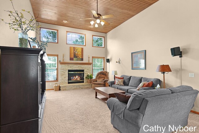 4232 Limousin Ct SW, Grandville, MI 49418 - carpeted living room featuring wooden ceiling, a towering ceiling, a stone fireplace, and ceiling fan