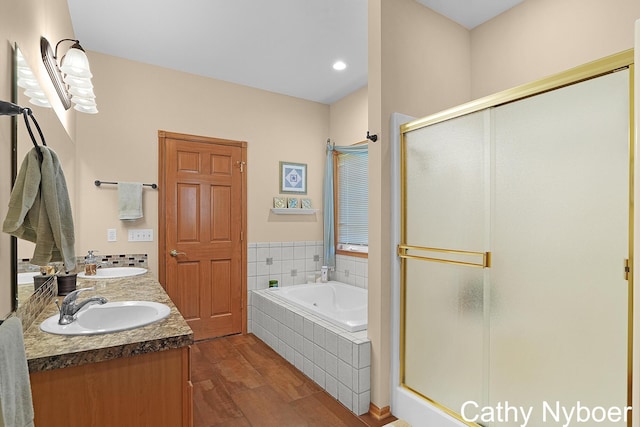 4232 Limousin Ct SW, Grandville, MI 49418 - bathroom featuring wood finished floors, a shower stall, a bath, and double vanity