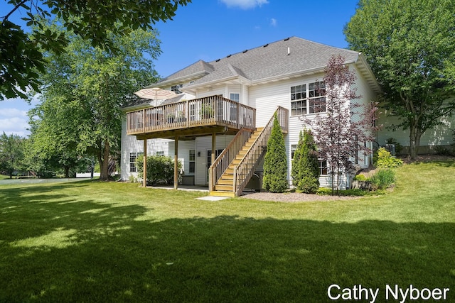 4232 Limousin Ct SW, Grandville, MI 49418 - back of property with stairway, a deck, a yard, and a shingled roof