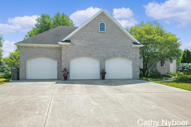 4232 Limousin Ct SW, Grandville, MI 49418 - view of front of property with brick siding, concrete driveway, and a shingled roof