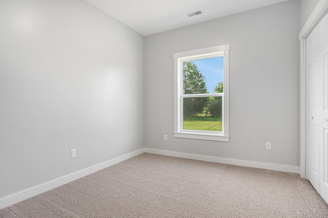 57860 James Dr, Three Rivers, MI 49093 - empty room featuring healthy amount of natural light and light colored carpet