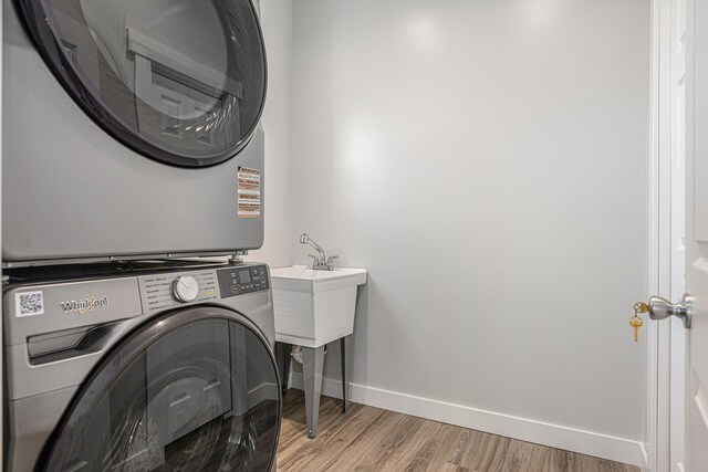 57860 James Dr, Three Rivers, MI 49093 - laundry room with estacked washer and dryer and light wood-type flooring