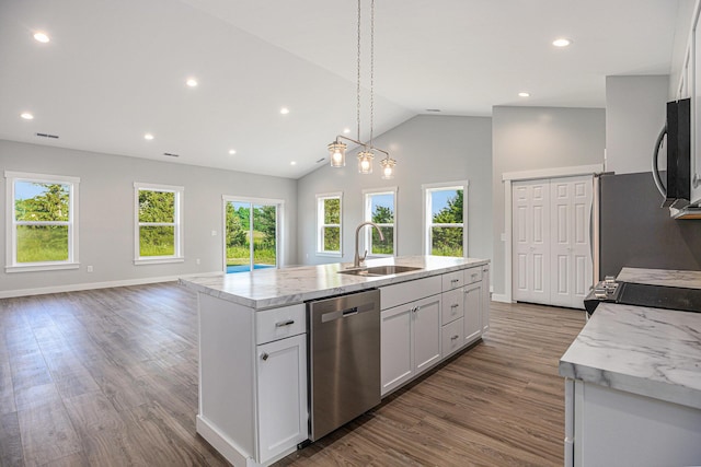 57860 James Dr, Three Rivers, MI 49093 - kitchen with stainless steel appliances, an island with sink, light stone counters, wood finished floors, and recessed lighting