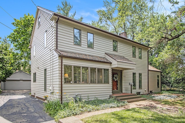 2425 University Ave, Kalamazoo, MI 49008 - view of front of home featuring a garage, a chimney, and an outbuilding
