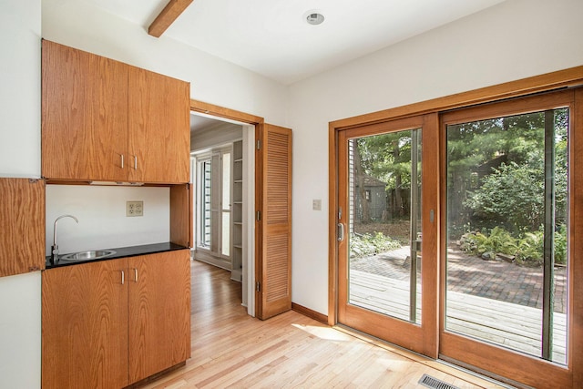 2425 University Ave, Kalamazoo, MI 49008 - entryway featuring plenty of natural light, light wood-style flooring, wet bar, and beamed ceiling