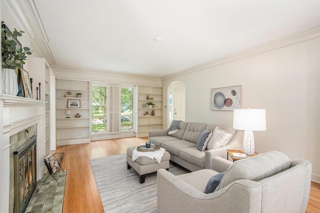 2425 University Ave, Kalamazoo, MI 49008 - living area with a fireplace, arched walkways, crown molding, wood finished floors, and built in features