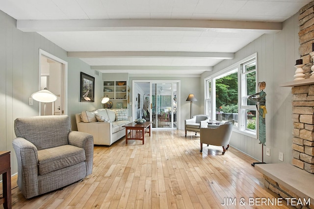 8518 146th Ave, West Olive, MI 49460 - living area featuring light wood-type flooring, beamed ceiling, and wood walls