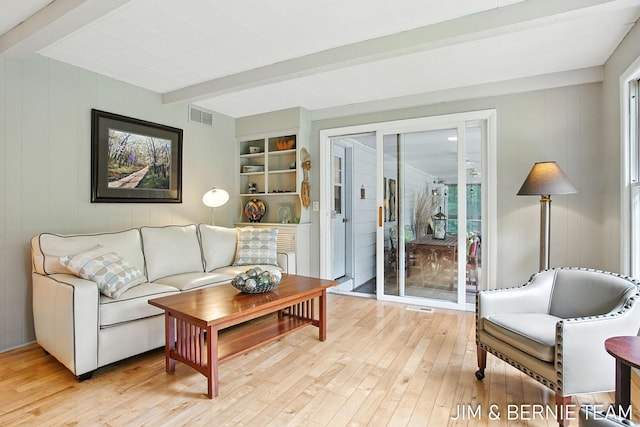 8518 146th Ave, West Olive, MI 49460 - living room featuring beam ceiling, light wood-type flooring, and wood walls