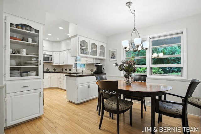 8518 146th Ave, West Olive, MI 49460 - dining area featuring light wood-style flooring and a chandelier
