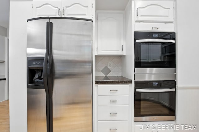 8518 146th Ave, West Olive, MI 49460 - kitchen featuring appliances with stainless steel finishes, white cabinets, and tasteful backsplash