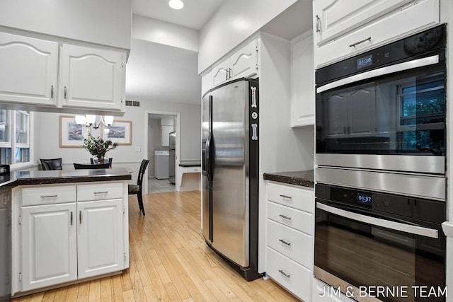 8518 146th Ave, West Olive, MI 49460 - kitchen featuring stainless steel appliances, white cabinets, dark countertops, light wood-style flooring, and recessed lighting
