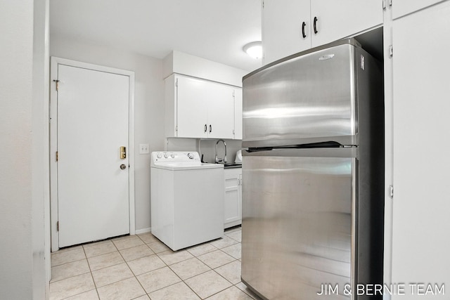 8518 146th Ave, West Olive, MI 49460 - laundry room with washer / dryer, cabinet space, and light tile patterned floors