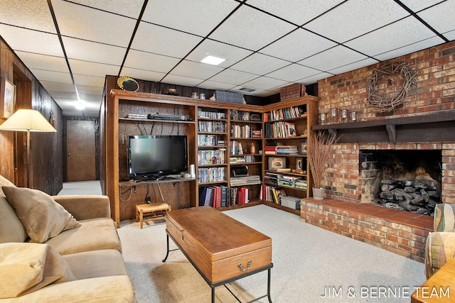 8518 146th Ave, West Olive, MI 49460 - carpeted living room with a paneled ceiling, a brick fireplace, and wooden walls