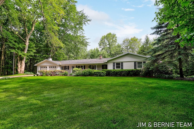 8518 146th Ave, West Olive, MI 49460 - single story home with an attached garage, a chimney, and a front yard