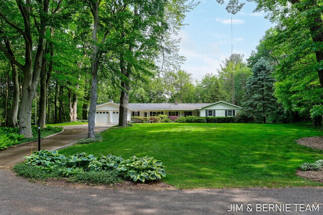 8518 146th Ave, West Olive, MI 49460 - ranch-style house with an attached garage, driveway, and a front yard
