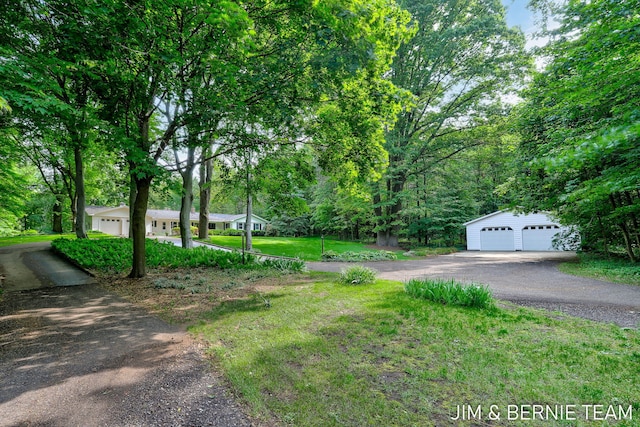 8518 146th Ave, West Olive, MI 49460 - view of grassy yard with a garage and an outbuilding