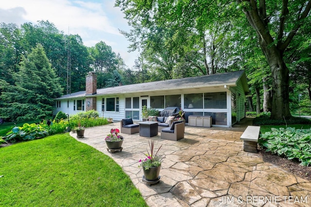 8518 146th Ave, West Olive, MI 49460 - back of house with a patio, a sunroom, a chimney, an outdoor hangout area, and a lawn