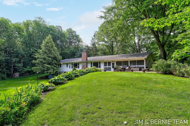 8518 146th Ave, West Olive, MI 49460 - ranch-style home with a sunroom, a front lawn, and a chimney
