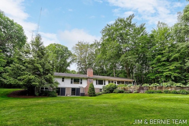 8518 146th Ave, West Olive, MI 49460 - rear view of property featuring a chimney and a lawn