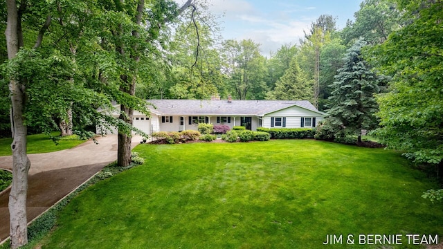 8518 146th Ave, West Olive, MI 49460 - single story home with driveway, a garage, a front lawn, and a chimney