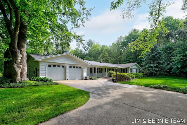 8518 146th Ave, West Olive, MI 49460 - ranch-style house with an attached garage, driveway, and a front lawn