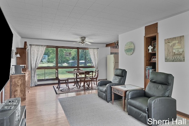 11956 Berrigan Ave NE, Cedar Springs, MI 49319 - living area with ceiling fan and wood finished floors