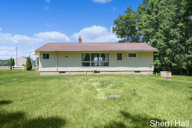 11956 Berrigan Ave NE, Cedar Springs, MI 49319 - rear view of house with a chimney and a yard