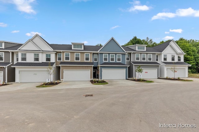 3345 Kings River St SW Unit 38, Wyoming, MI 49418 - view of property featuring an attached garage and concrete driveway