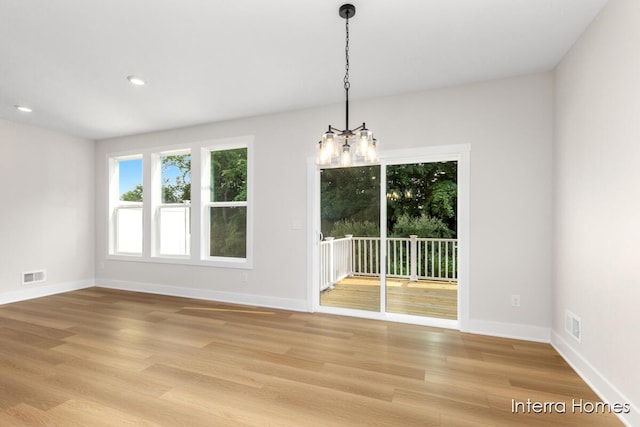 3345 Kings River St SW Unit 38, Wyoming, MI 49418 - spare room featuring light wood finished floors, a chandelier, and recessed lighting
