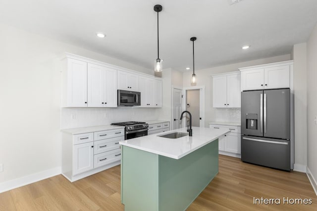 3345 Kings River St SW Unit 38, Wyoming, MI 49418 - kitchen featuring stainless steel appliances, backsplash, white cabinets, light countertops, and light wood-style floors