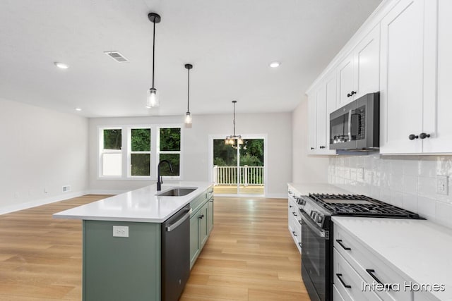 3345 Kings River St SW Unit 38, Wyoming, MI 49418 - kitchen with appliances with stainless steel finishes, light wood finished floors, decorative backsplash, plenty of natural light, and recessed lighting